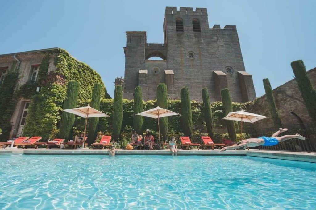 Outdoor pool view of Hôtel de la Cité Carcassonne, a luxury family-friendly hotel inside the medieval city walls of Carcassonne, France