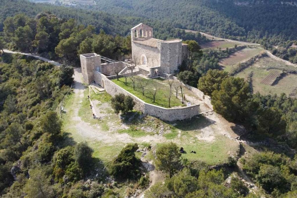 Aerial view of Château de Montségur perched atop its rocky peak in the Pyrenees — once the last stronghold of the Cathars and now a hauntingly beautiful ruin steeped in legend.