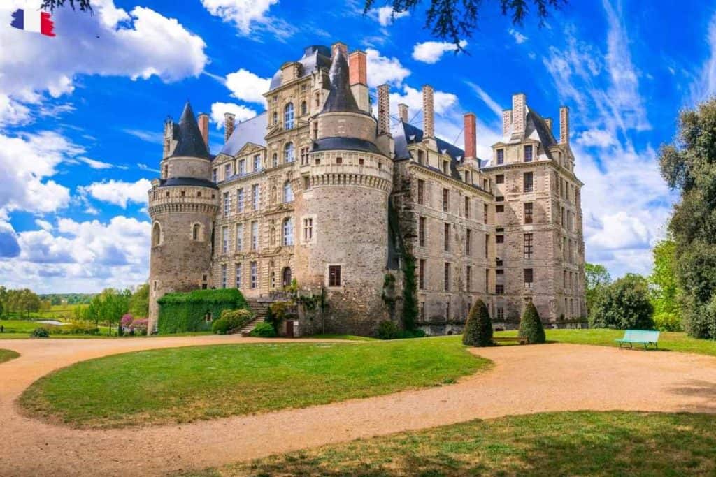 Château de Brissac rising above manicured gardens in the Loire Valley — known as France’s tallest castle and home to the ghostly legend of the Green Lady.