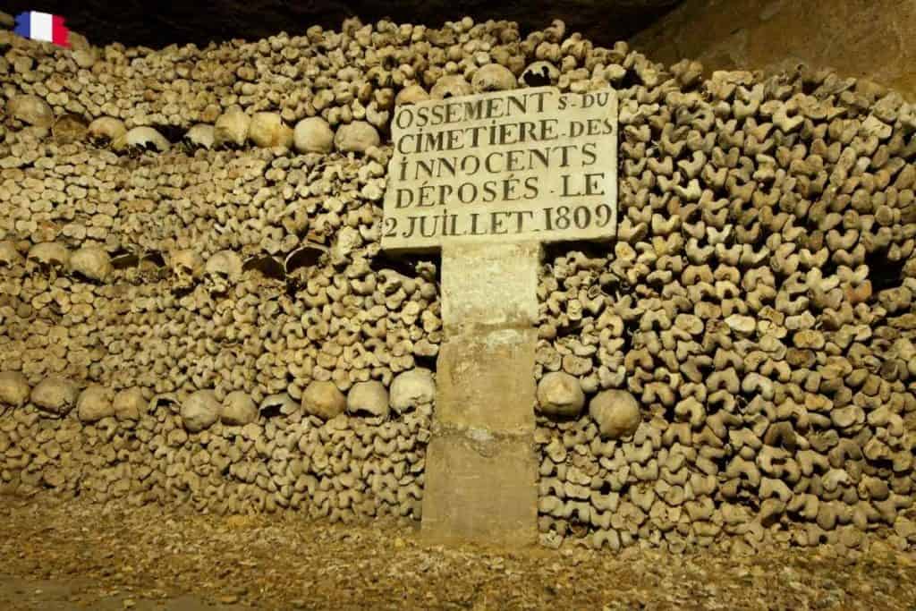 Eerie underground corridor lined with skulls and bones in the Paris Catacombs — a haunting reminder of the city’s layered past and one of its most mysterious attractions.