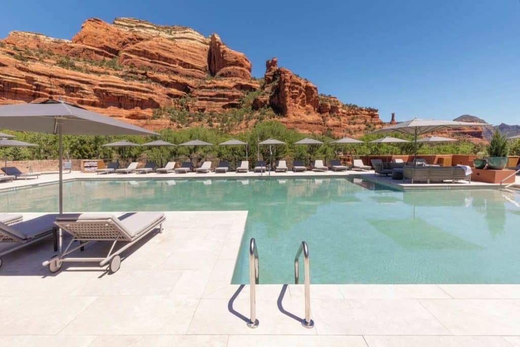 Two outdoor pools at Enchantment Resort in Arizona with sun loungers and umbrellas