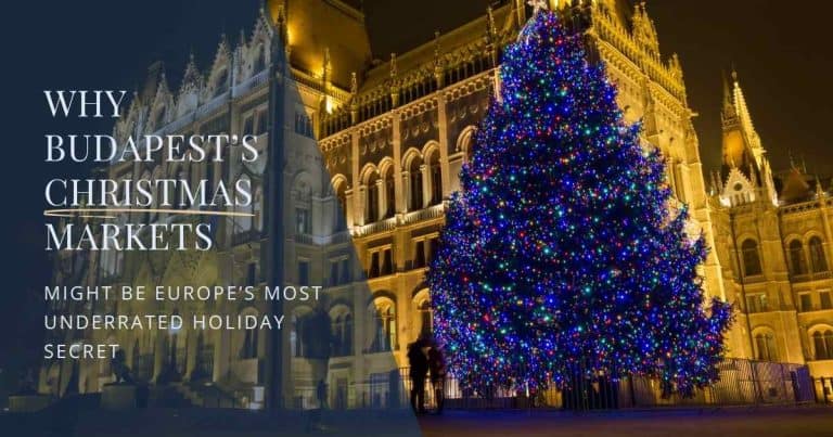 Budapest Parliament lit up at night with a glowing Christmas tree in front during the holiday season