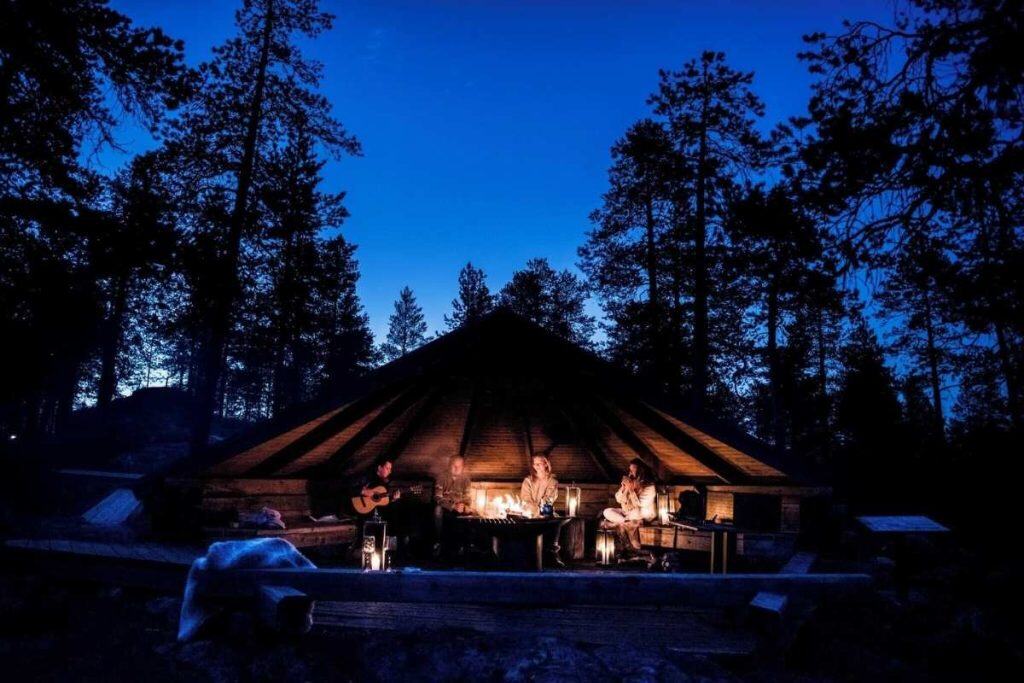 Guests sitting by the fire at Arctic TreeHouse Hotel in Lapland