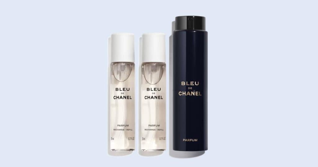 Bleu de Chanel travel spray cologne on light blue background