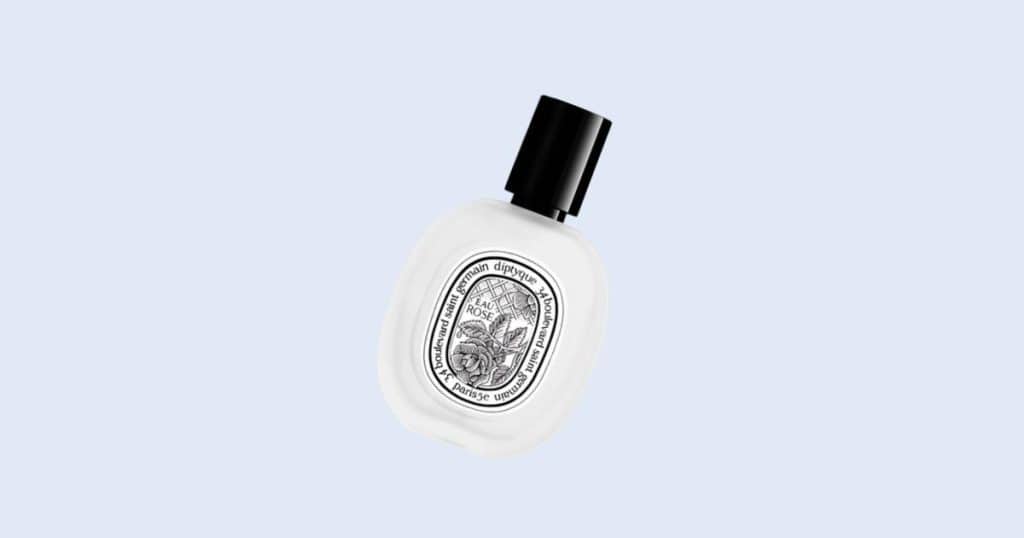 Diptyque Philosykos travel spray perfume on light blue background