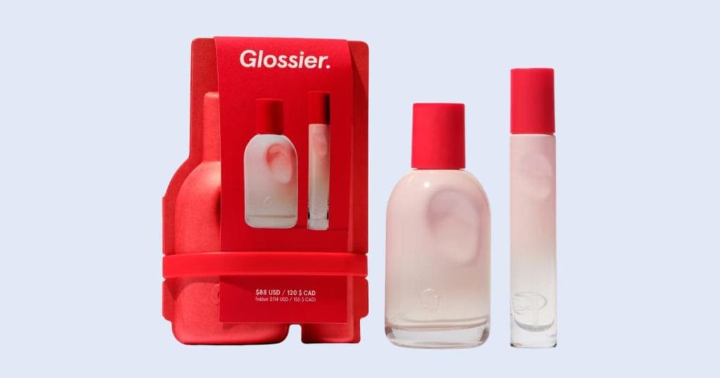 Glossier You travel spray perfume on light blue background