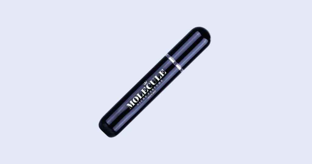 Tom Ford Oud Wood travel atomizer perfume on light blue background