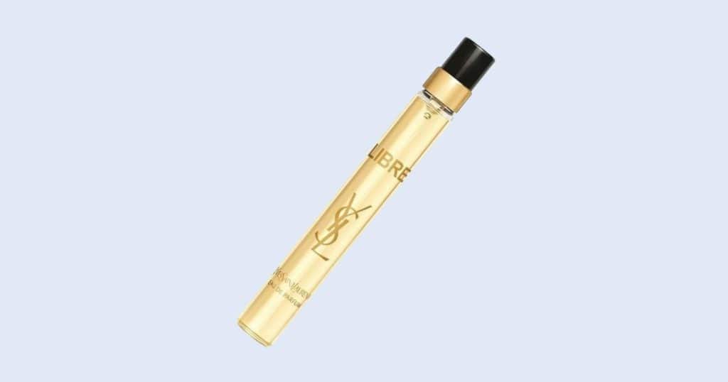 Yves Saint Laurent Libre travel spray perfume on light blue background